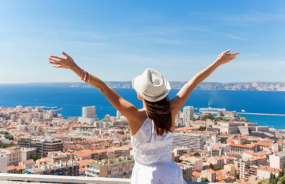 Woman celebrating travel overlooking a coastal city